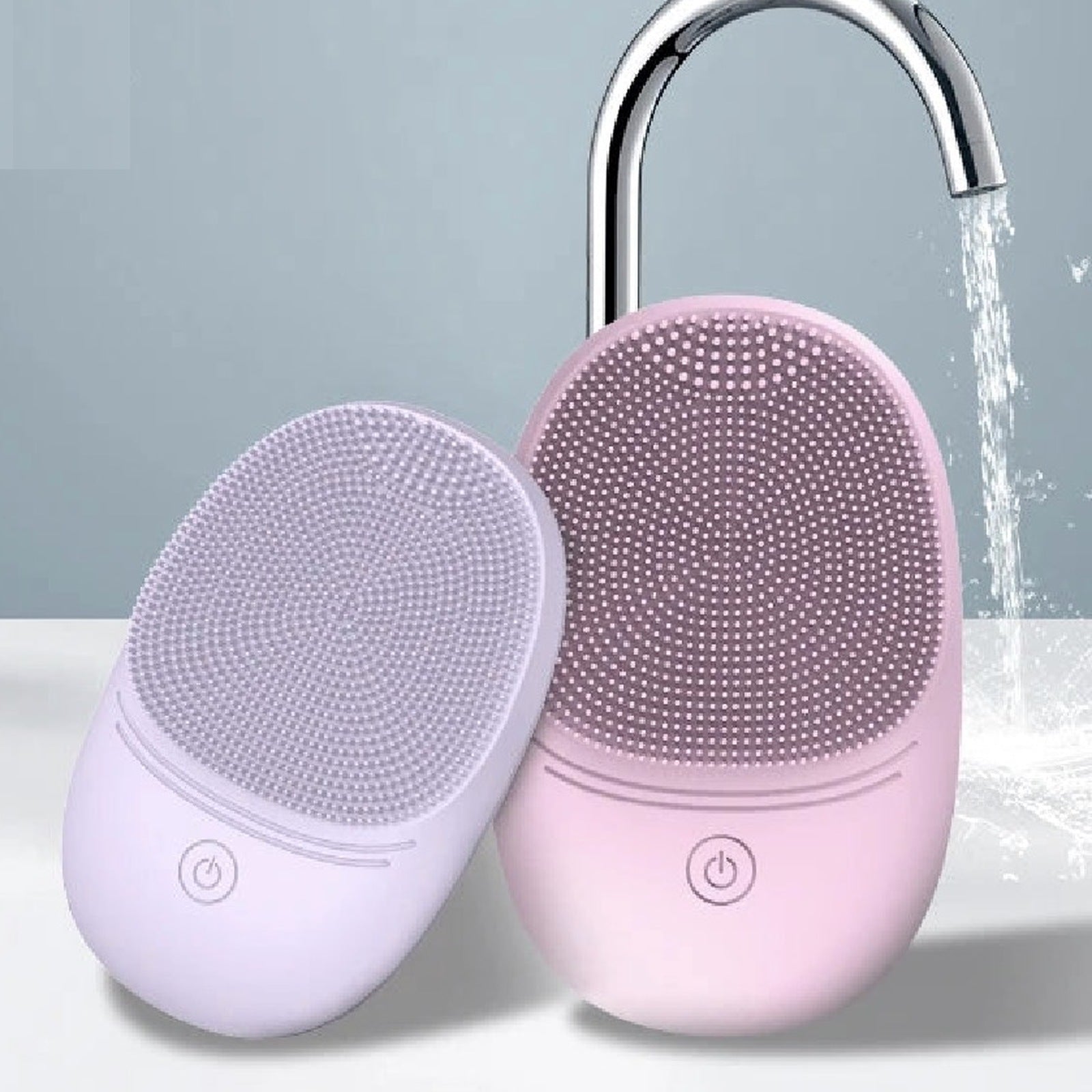Pura Sonic Cleansing Brush in lavender and pink under running water