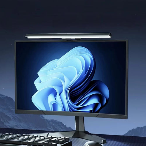 Aurora monitor light bar casting glare-free light across a desk